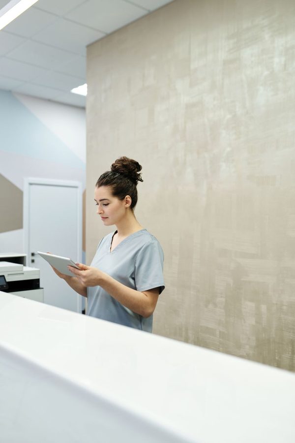 Dental professional greeting a patient in a bright clinic